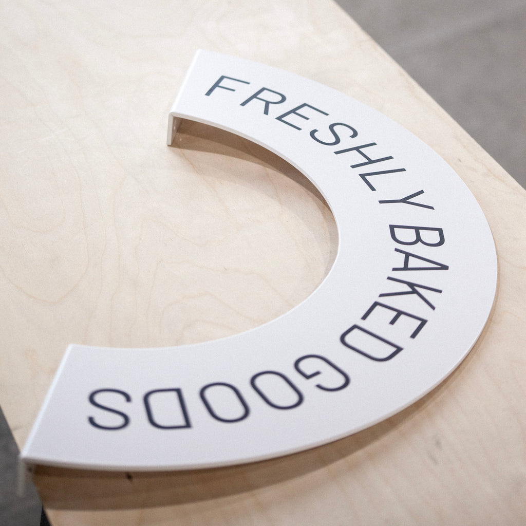 Rainbow-shaped blade sign